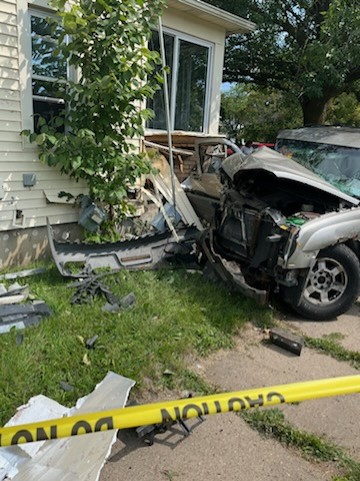 Car crashes into Lansing home, causes gas leak