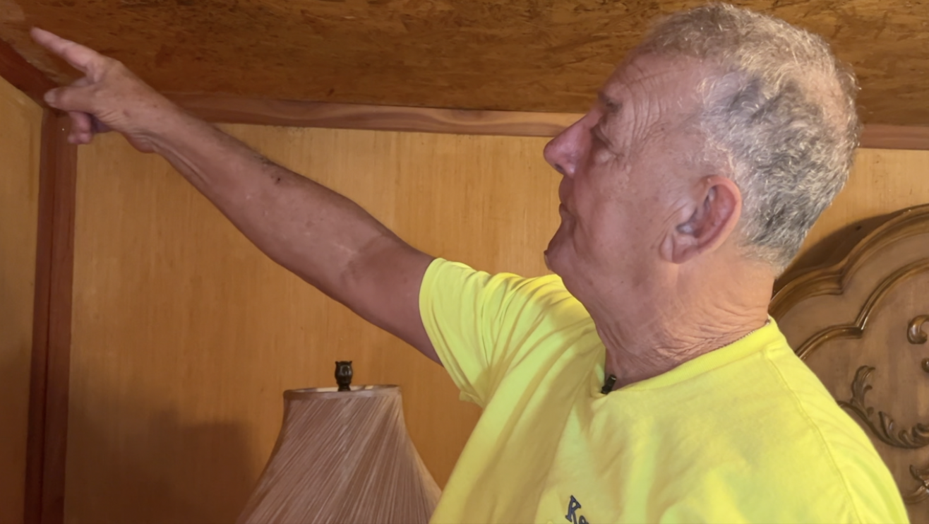 Neighbor William Terry shares where water damage has affected his home from hurricanes 