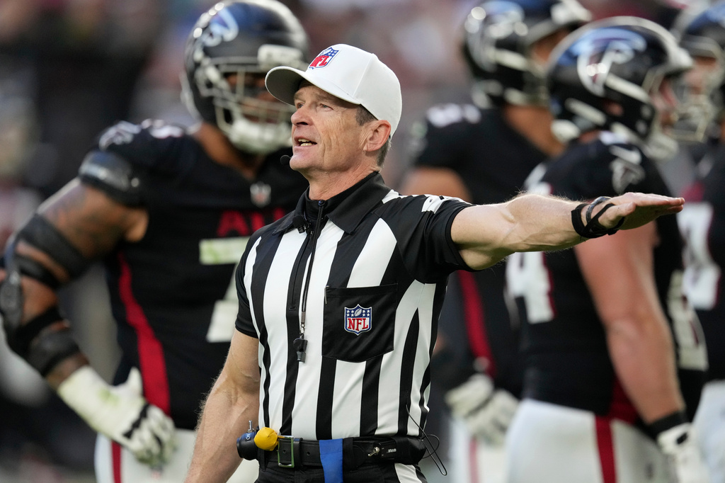 Referee Land Clark annouces a penalty during the second half of an NFL football game between the Arizona Cardinals and the Atlanta Falcons Sunday, Dec. 21, 2025, in Glendale, Ariz. 