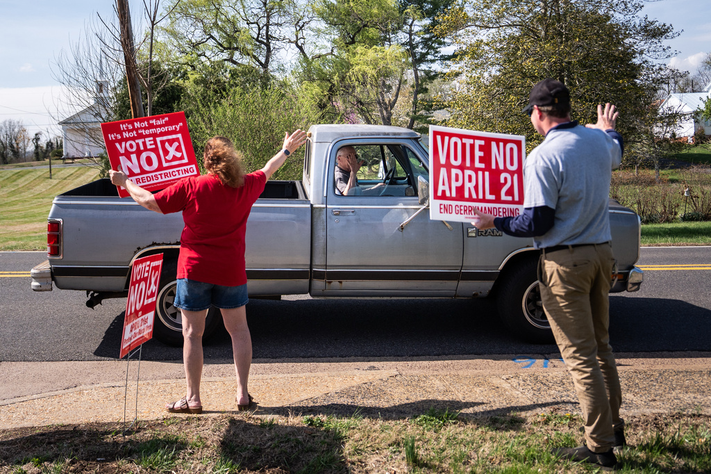 A truck driver stops to wave at members of the Madison County Republican Committee as they hold signs opposing the Virginia redistricting referendum, during the early voting period, Friday, April 3, 2026, in Madison, Va. 