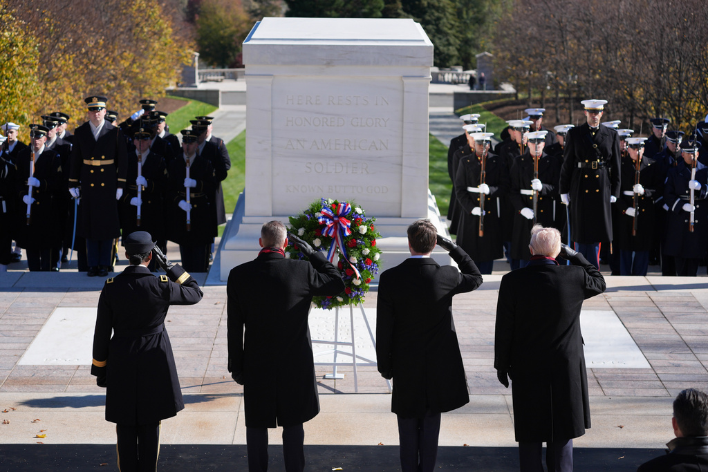 President Donald Trump, right, salutes during a wreath laying ceremony at the Tomb of the Unknown Soldier at Arlington National Cemetery, Tuesday, Nov. 11, 2025, in Arlington, Va.