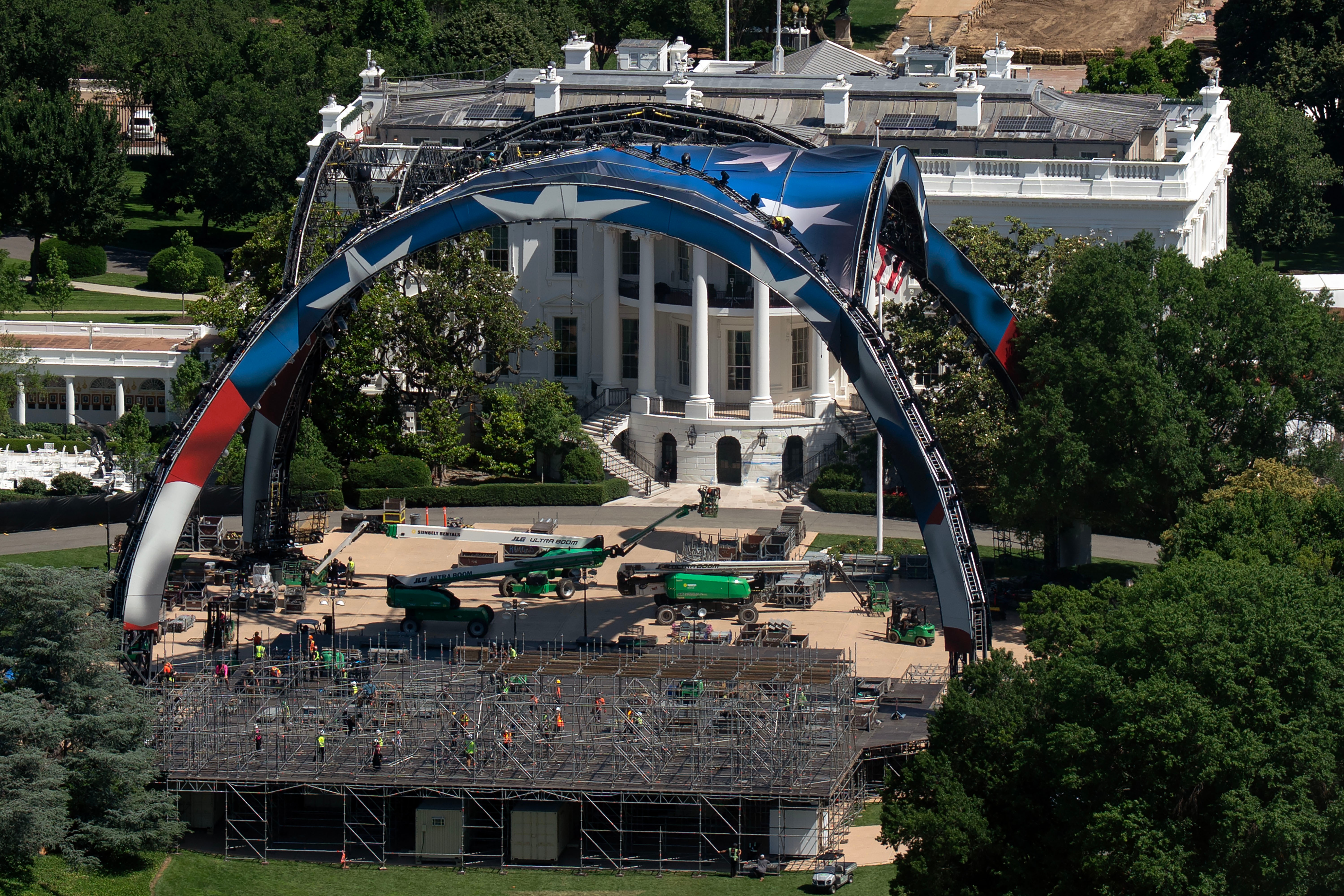 Workers continue building the cage for a future UFC fight on the South Lawn in front of the White House, Saturday, May 30 2026, in Washington, as seen from the Washington Monument.