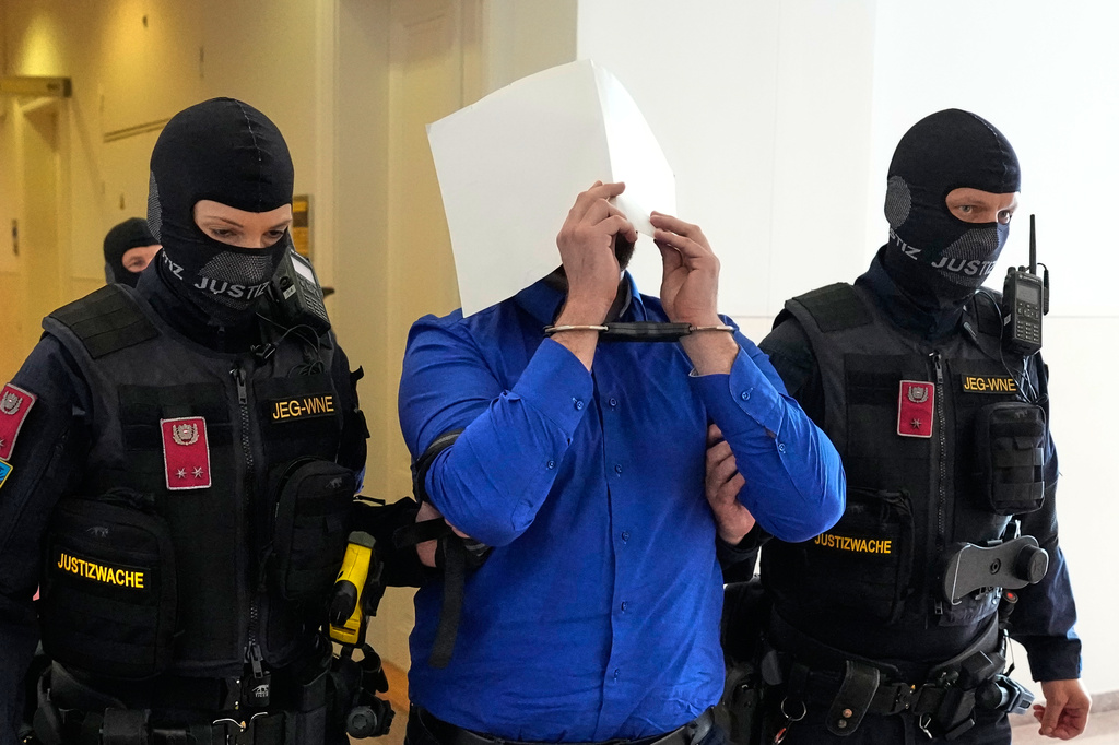 Defendant Beran A. is hiding his face behind file folders when he is escorted out of the courtroom in the District Court in Wiener Neustadt, Austria, where he stands trial for plotting to carry out an attack on one of superstar singer Taylor Swift's concerts in Vienna in August 2024 and pledging allegiance to the Islamic State group, Tuesday, April 28, 2026.