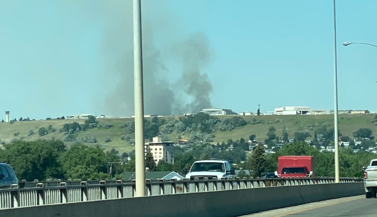 A cloud of dark smoke can be seen at or near Great Falls International Airport. 
