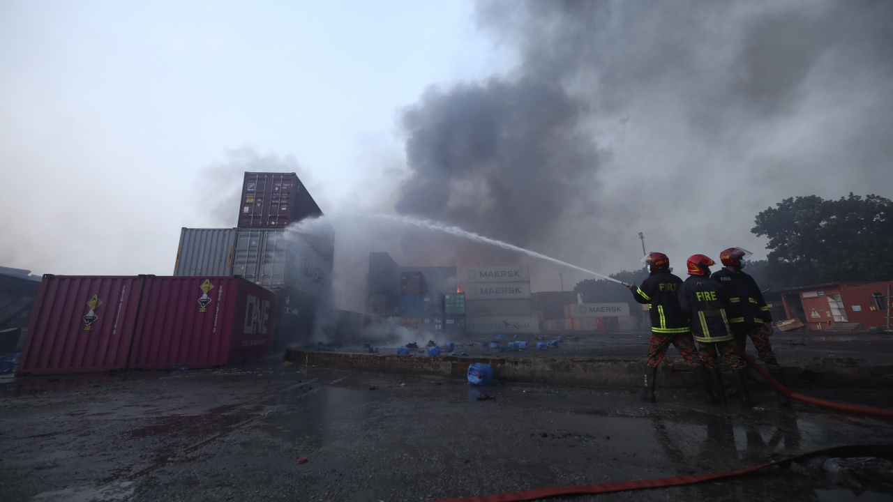 Firefighters work to contain a fire that broke out at the BM Inland Container Depot