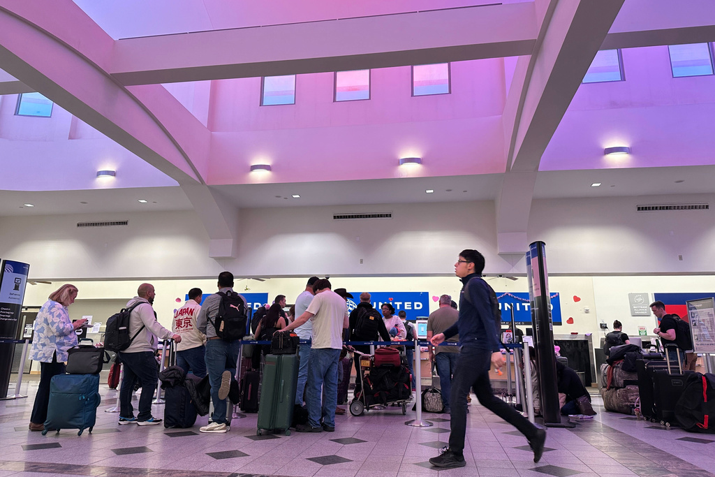 People stand in line at check-in counters at El Paso International Airport, Wednesday, Feb. 11, 2026, in El Paso, Texas.