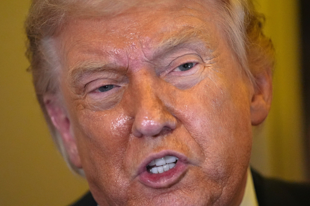 President Donald Trump speaks to reporters aboard Air Force One, Friday, May 15, 2026, as he returns from a trip to Beijing, China.