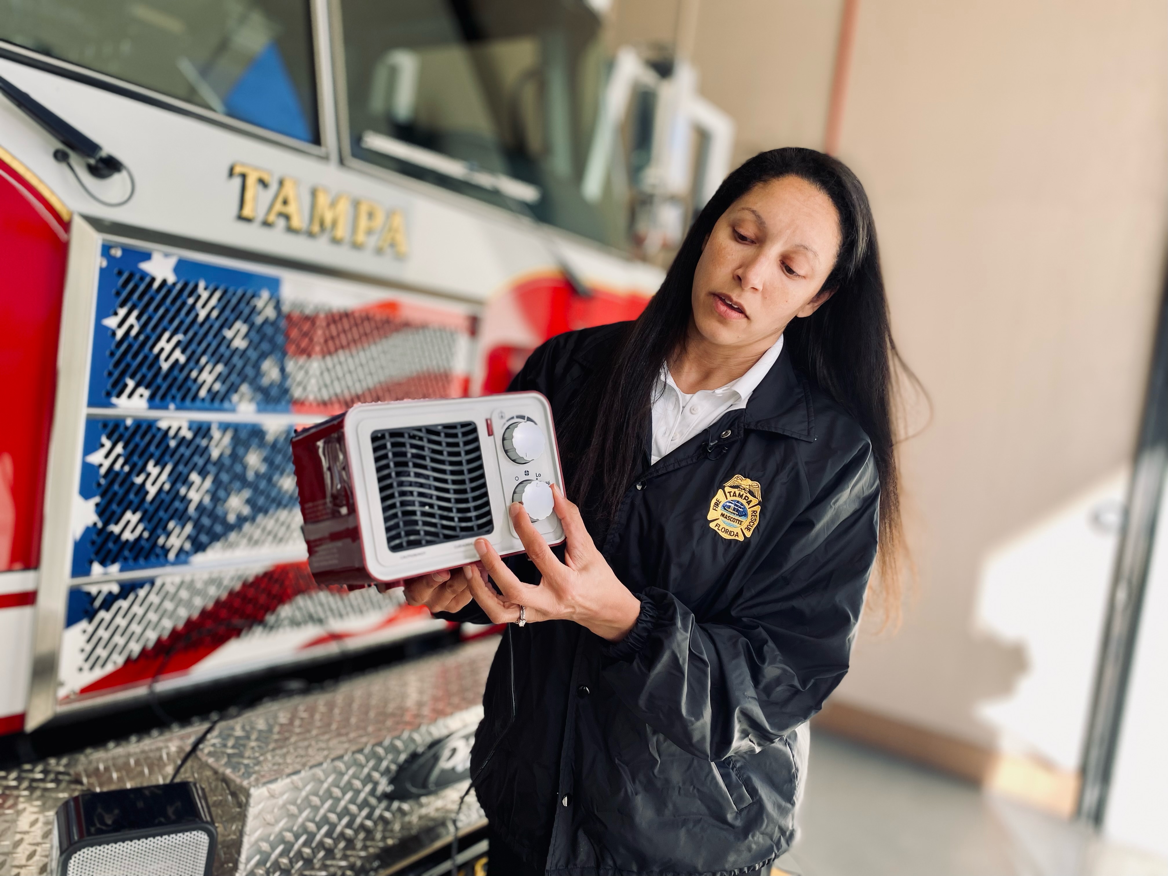 Vivian Shedd with Tampa Fire Rescue holding a space heater.