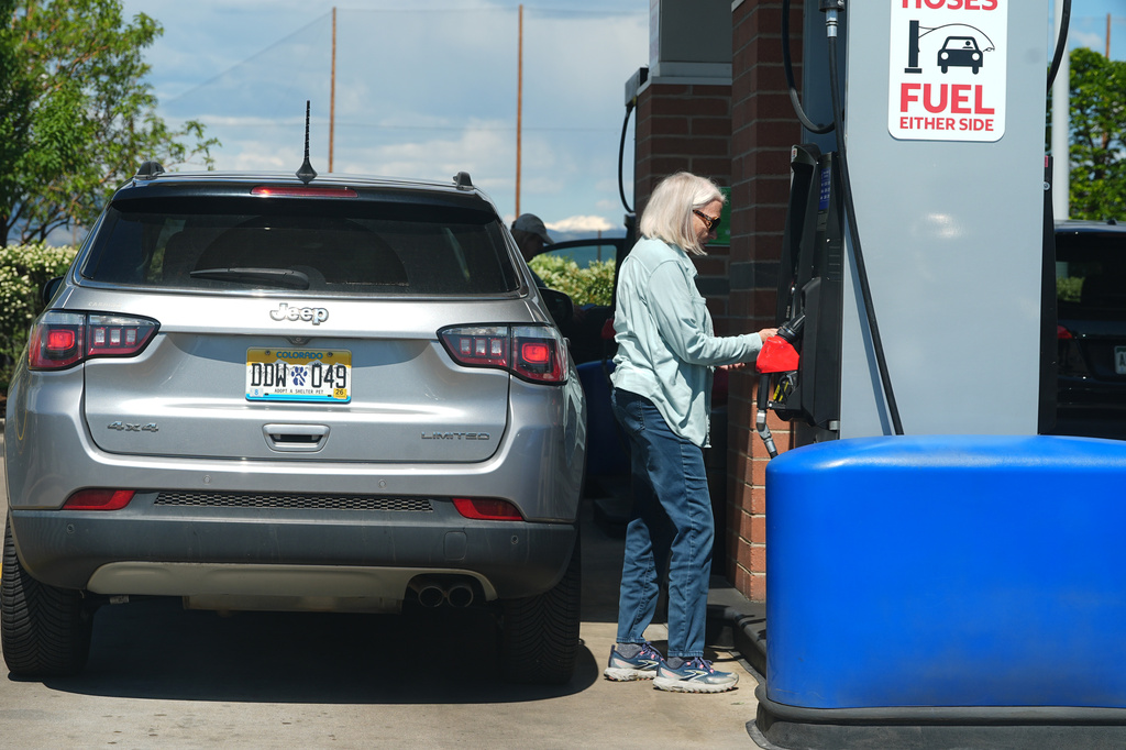A motorist swipes a credit card at the pump to pay for gasoline at a gas station, Sunday, May 24, 2026, in Sheridan, Colo.