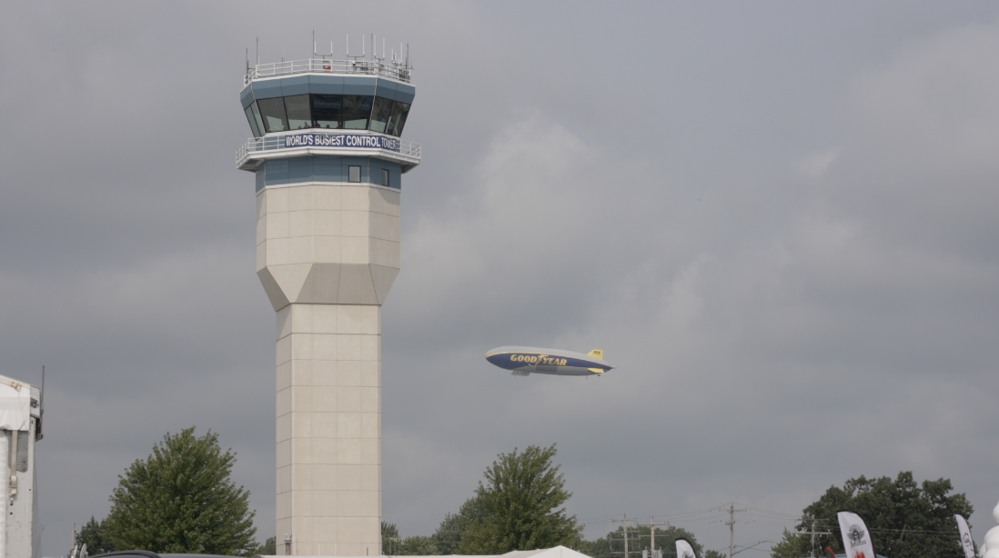The EAA air traffic control tower beside the Goodyear Blimp.