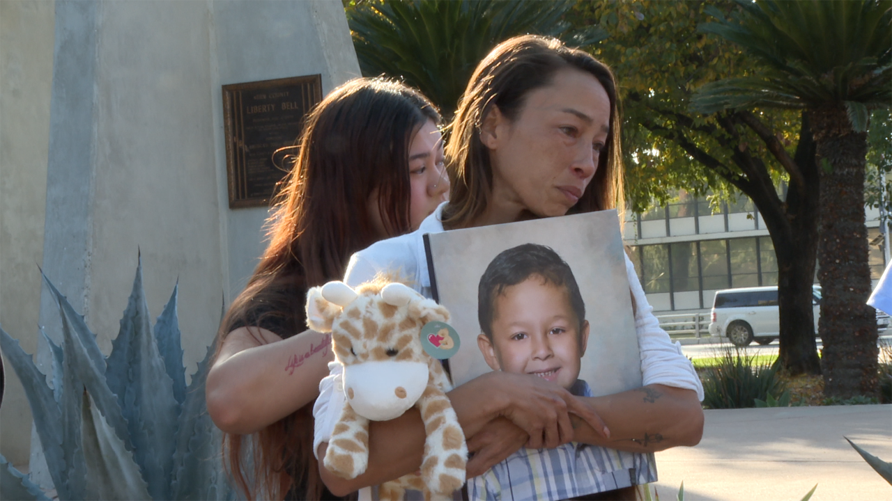 Stephanie, the mother of Xxavien Hernandez holds his photograph outside the Kern County Superior Courthouse.