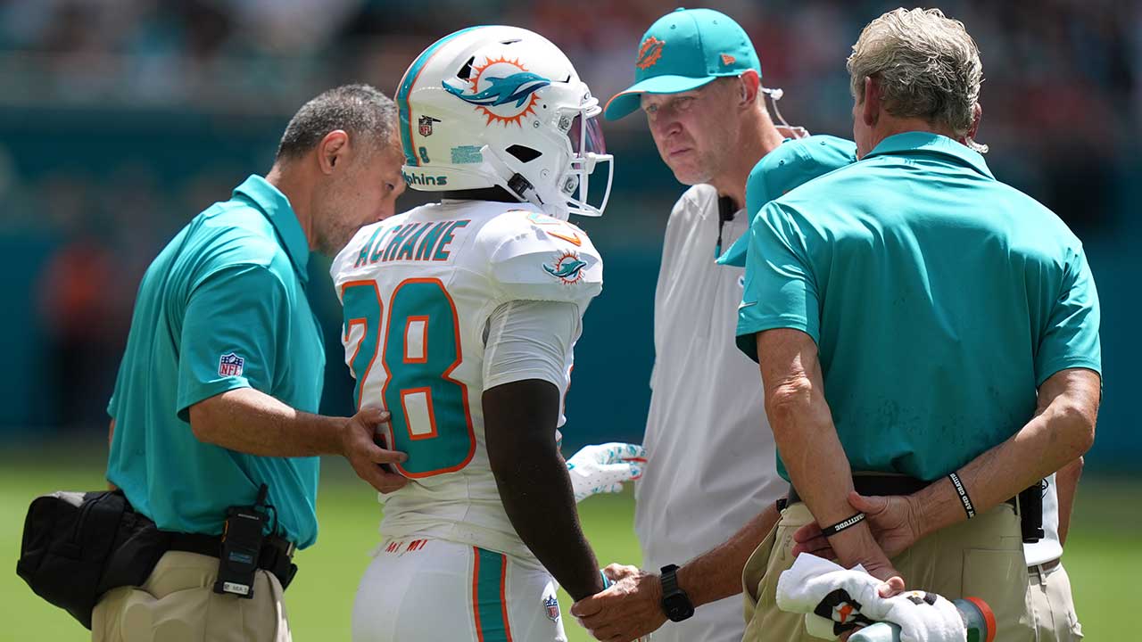 Miami Dolphins running back De'von Achane (28) stands with the coaching staff after an injury during the first half of an NFL football game against the Kansas City Chiefs in Miami Gardens, Fla., Sunday, Sept. 27, 2026. (AP Photo/Lynne Sladky)
