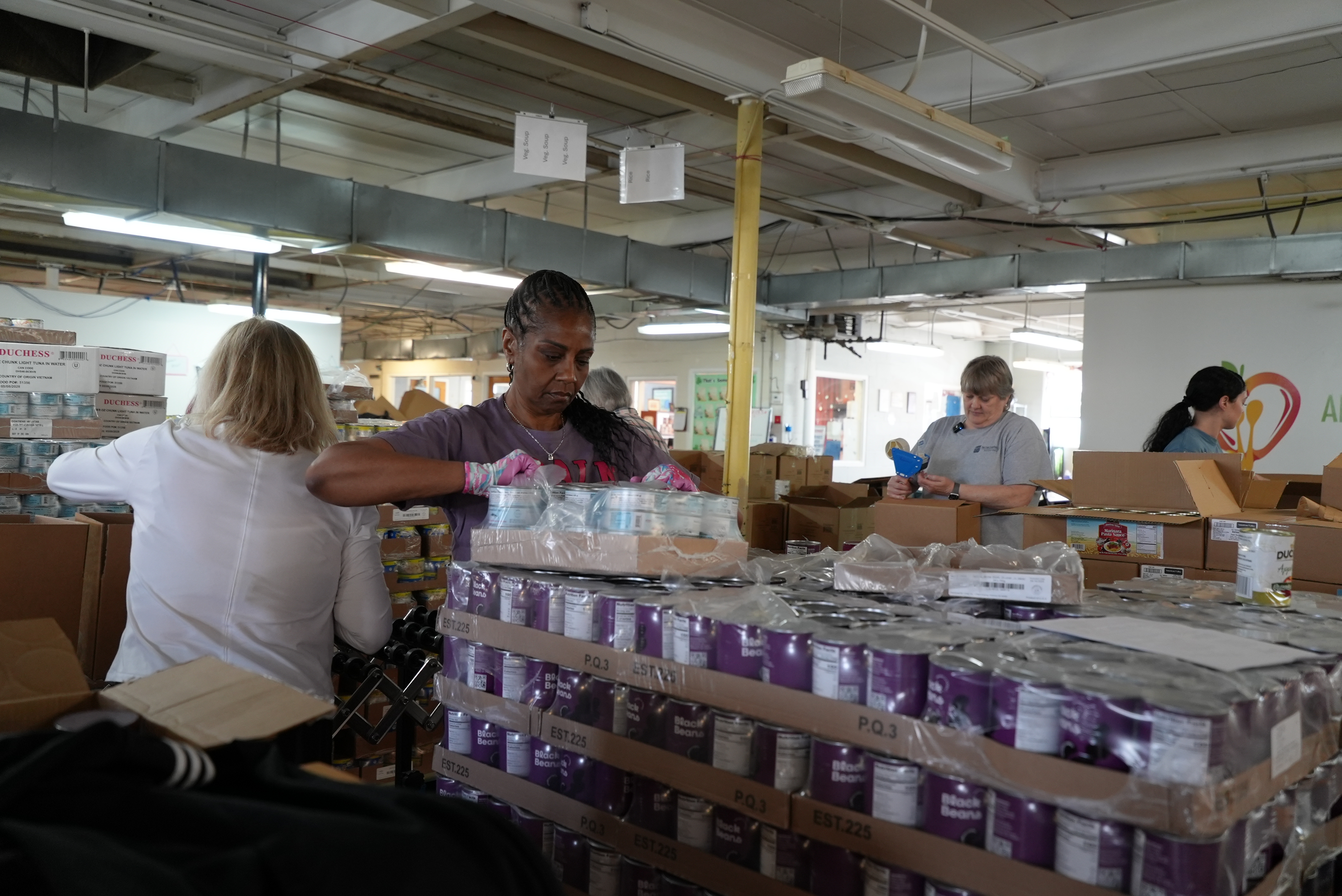 Volunteers filling boxes at the Anne Arundel County Food Bank