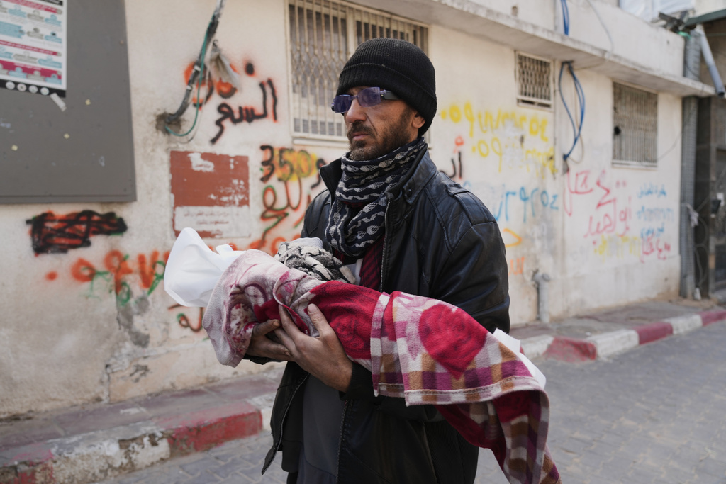 Khalid Abu Jarad holds the body of his 3-month-old niece, Shaza Abu Jarad, who, according to the health ministry, died from hypothermia, in Gaza City, Tuesday, Jan. 20, 2026. 
