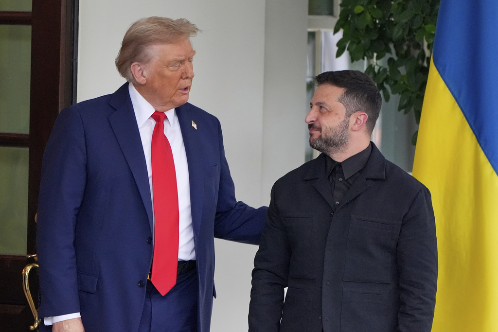 President Donald Trump, left, greets Ukraine's President Volodymyr Zelenskyy as he arrives at the White House, Monday, Aug. 18, 2025, in Washington. 