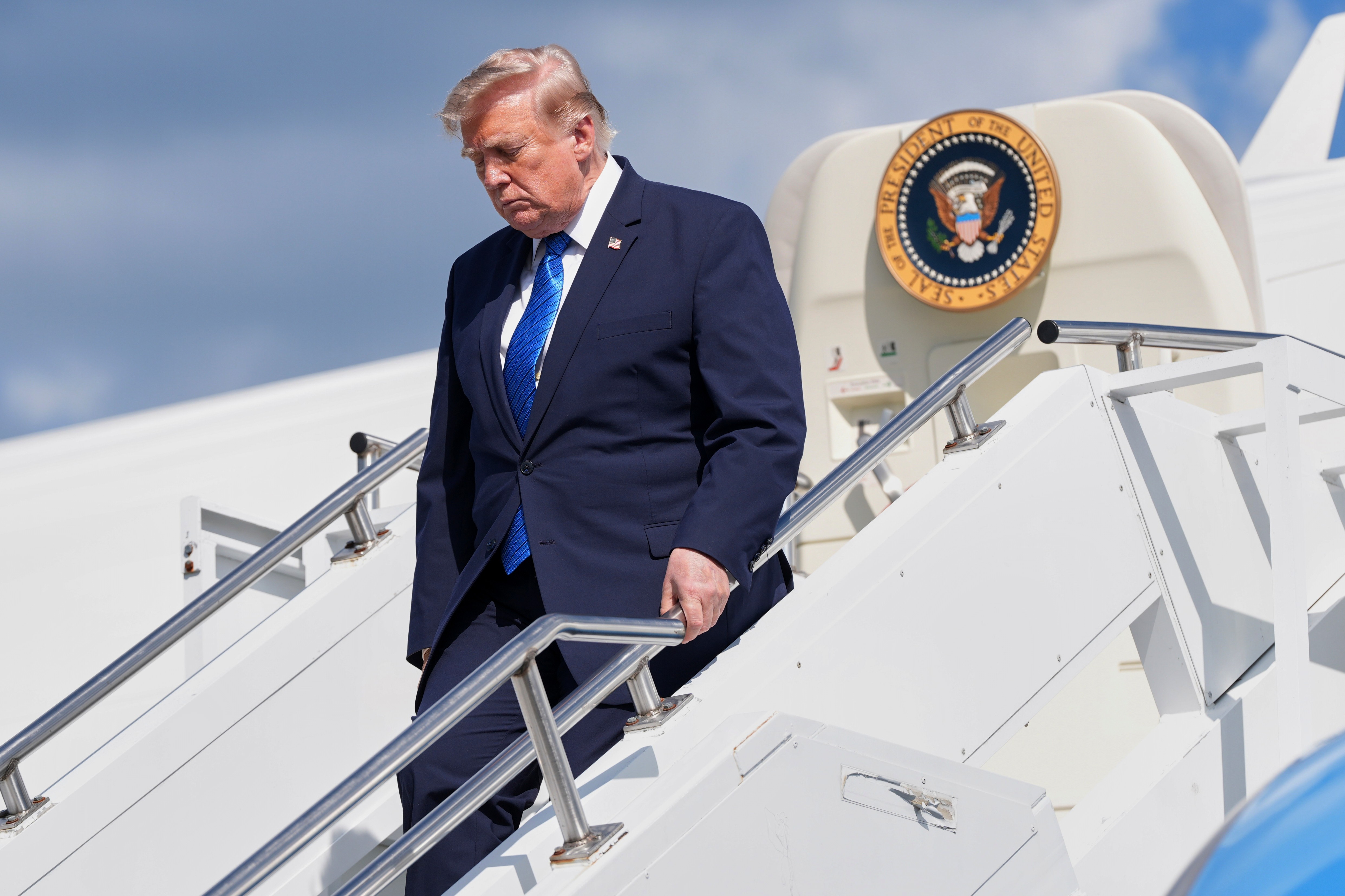 President Donald Trump exits Air Force One at Morristown Municipal Airport in Morristown, N.J., Friday, July 31, 2026, after a trip to Camp David, the presidential retreat.