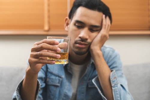 Stock image of a man holding an alcoholic beverage.