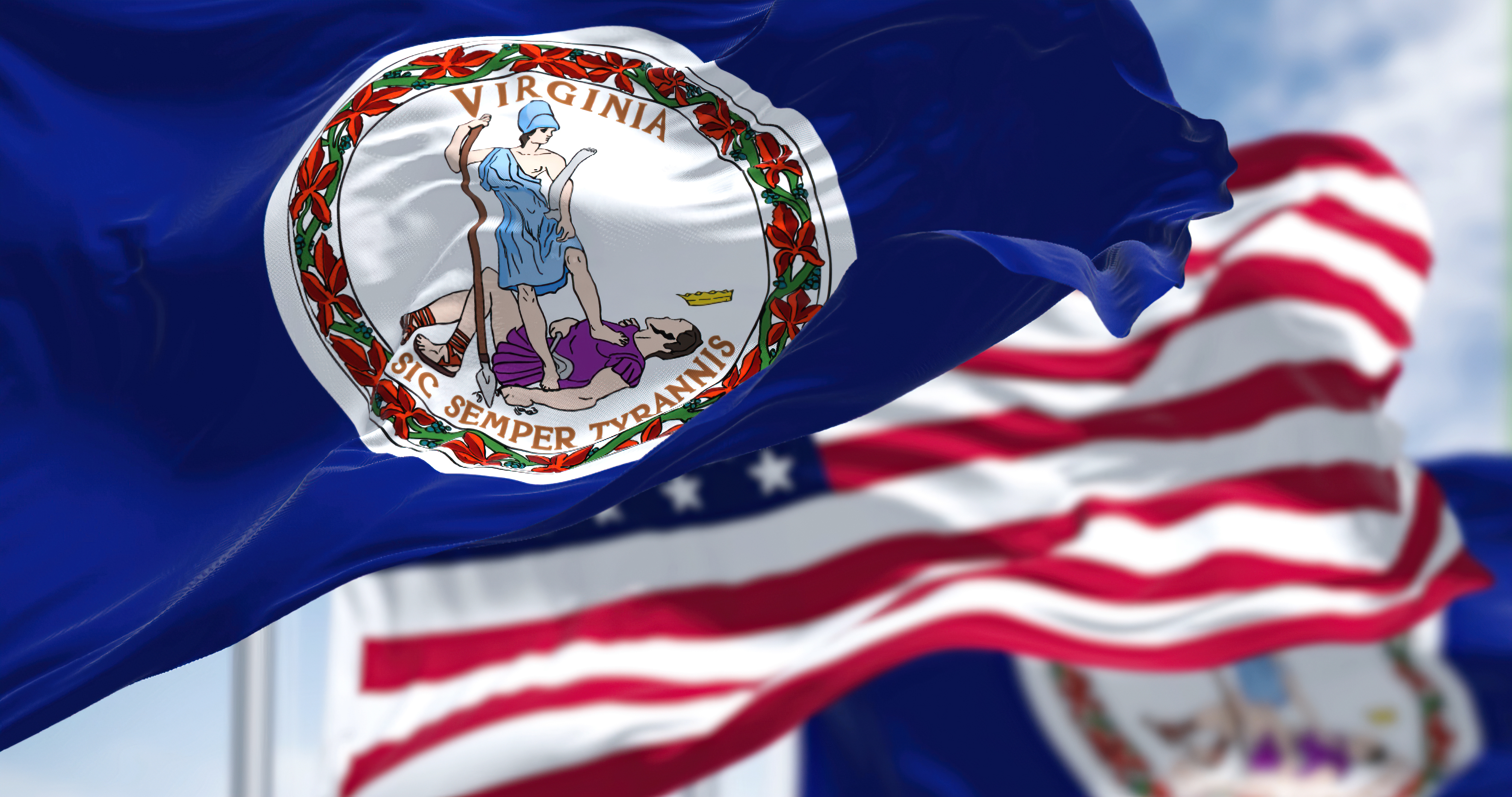 The Virginia state flag waving along with the national flag of the United States of America