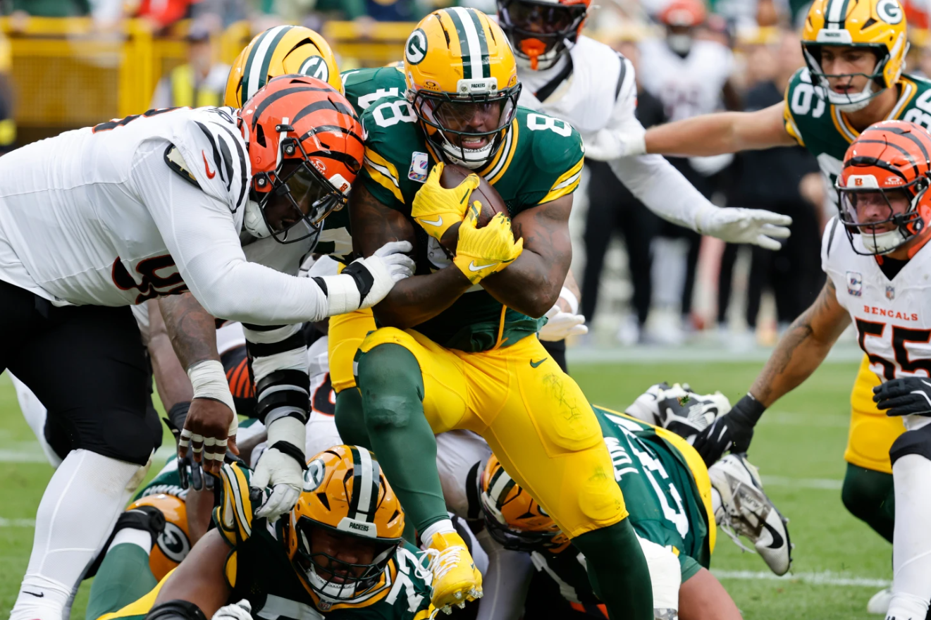 Green Bay Packers running back Josh Jacobs (8) scores a touchdown against the Cincinnati Bengals in the first half of an NFL football game, Sunday, Oct. 12, 2025, in Green Bay, Wis.