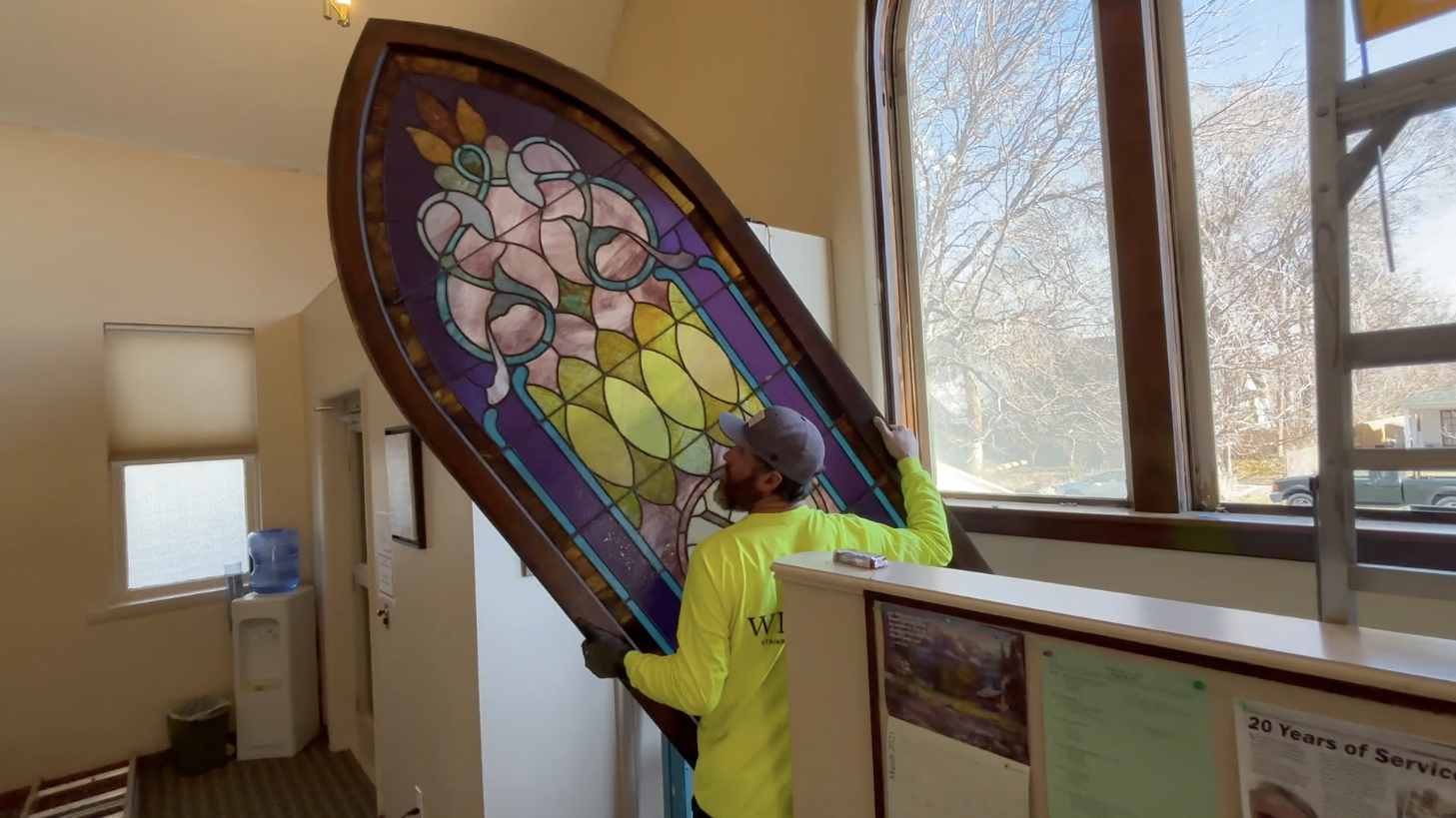 A worker removes a 120-year-old stained glass at rock Creek Church in Twin Falls on Tuesday, March 11, 2025