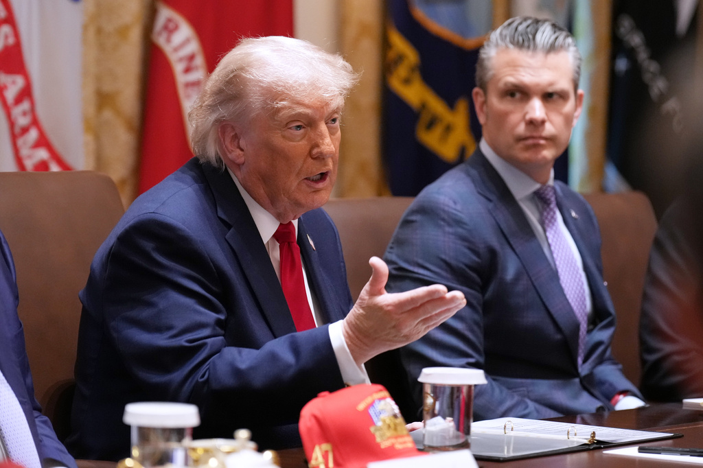 President Donald Trump speaks during a Cabinet meeting at the White House, Wednesday, May 27, 2026, in Washington, as Secretary of Defense Pete Hegseth, looks on. 