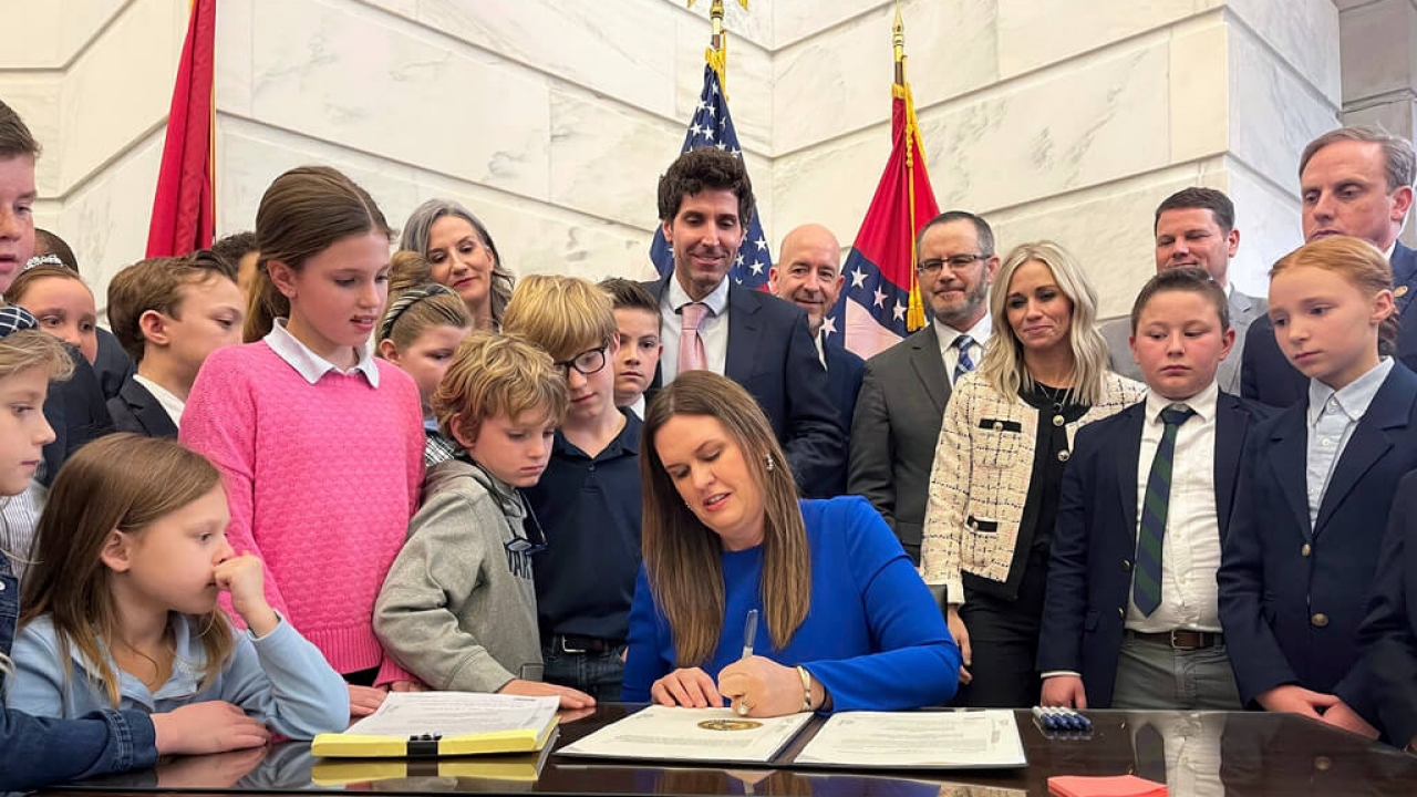 Arkansas Gov. Sarah Huckabee Sanders signs an education bill into law on March 8, 2023.
