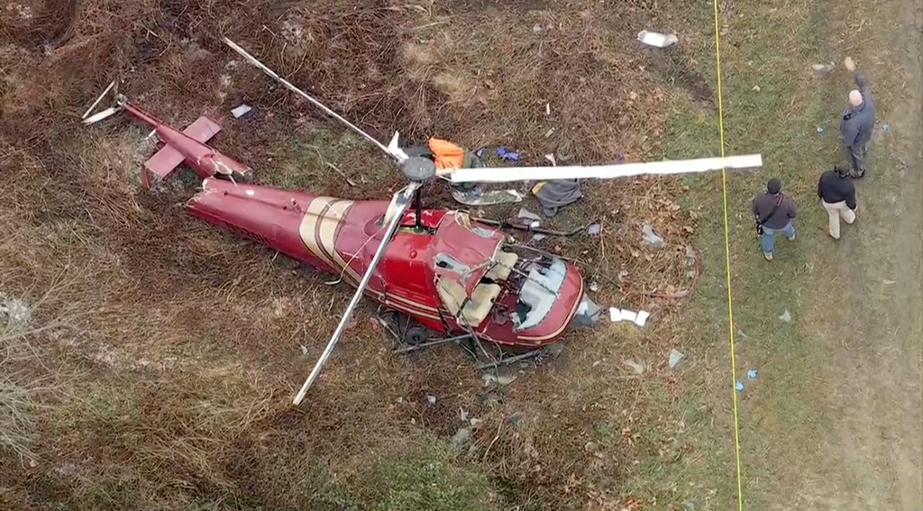 Authorities look over the scene after two helicopters crashed in Hammonton, N.J., on Sunday, Dec. 28, 2025. 