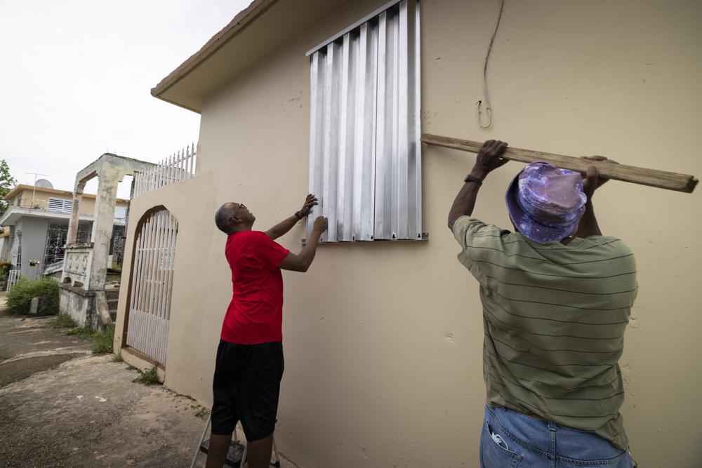 Residents prepare for the arrival of Tropical Storm Fiona, in Loiza, Puerto Rico, Saturday, Sept. 17, 2022. Fiona was expected to become a hurricane as it neared Puerto Rico on Saturday, threatening to dump up to 20 inches (51 centimeters) of rain as people braced for potential landslides, severe flooding and power outages. (AP Photo/Alejandro Granadillo)
