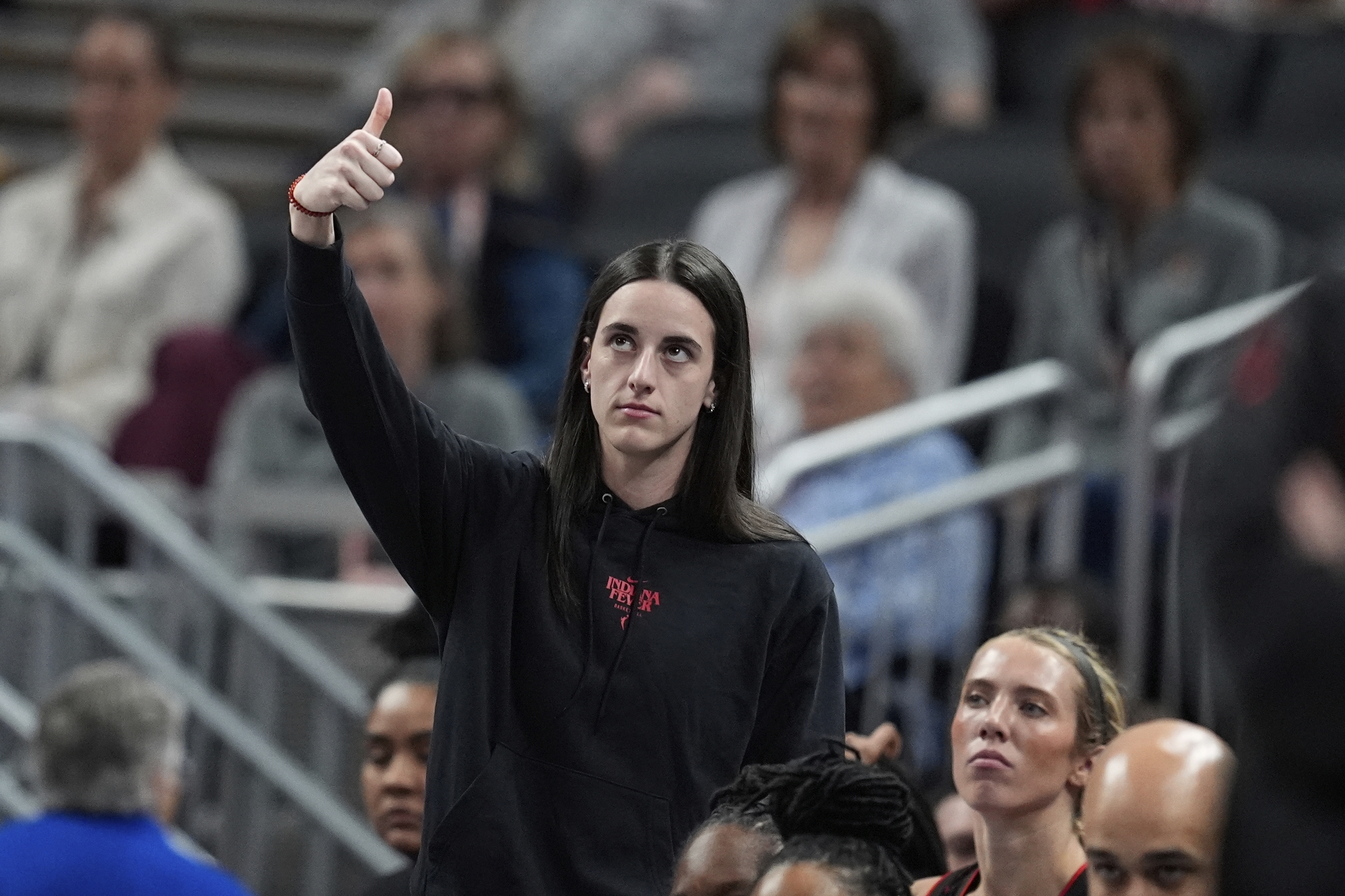 Indiana Fever's Caitlin Clark reacts on the sideline during the first half of a WNBA basketball game against the Las Vegas Aces, Thursday, July 24, 2025, in Indianapolis. 