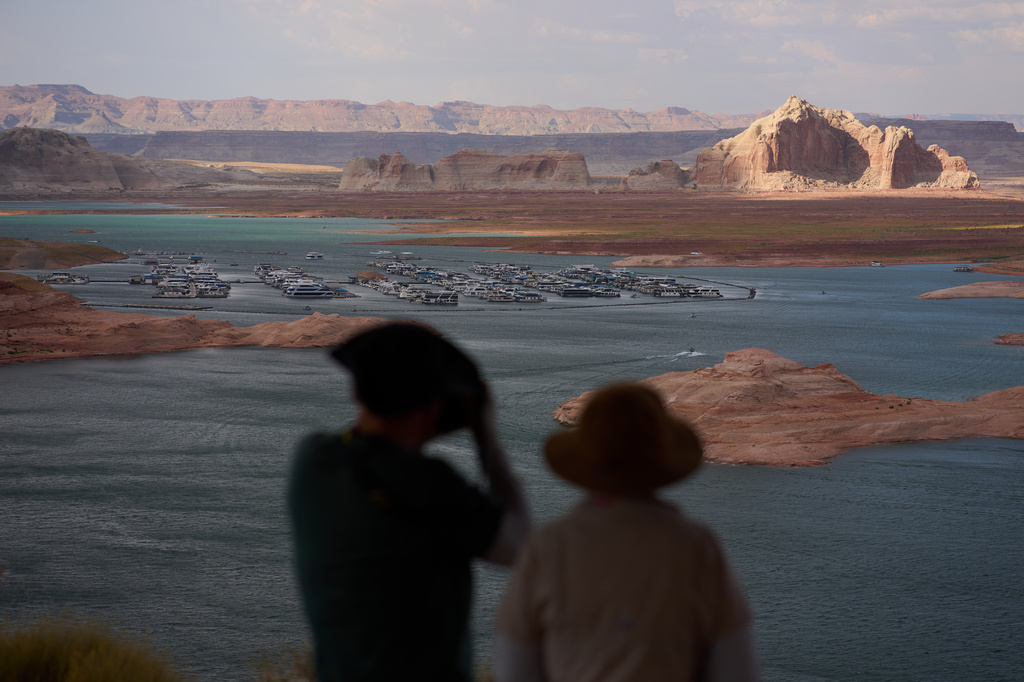 People stand on a lookout on Lake Powell at the Glen Canyon National Recreation Area, Tuesday, July 14, 2026, near Page, Nev.