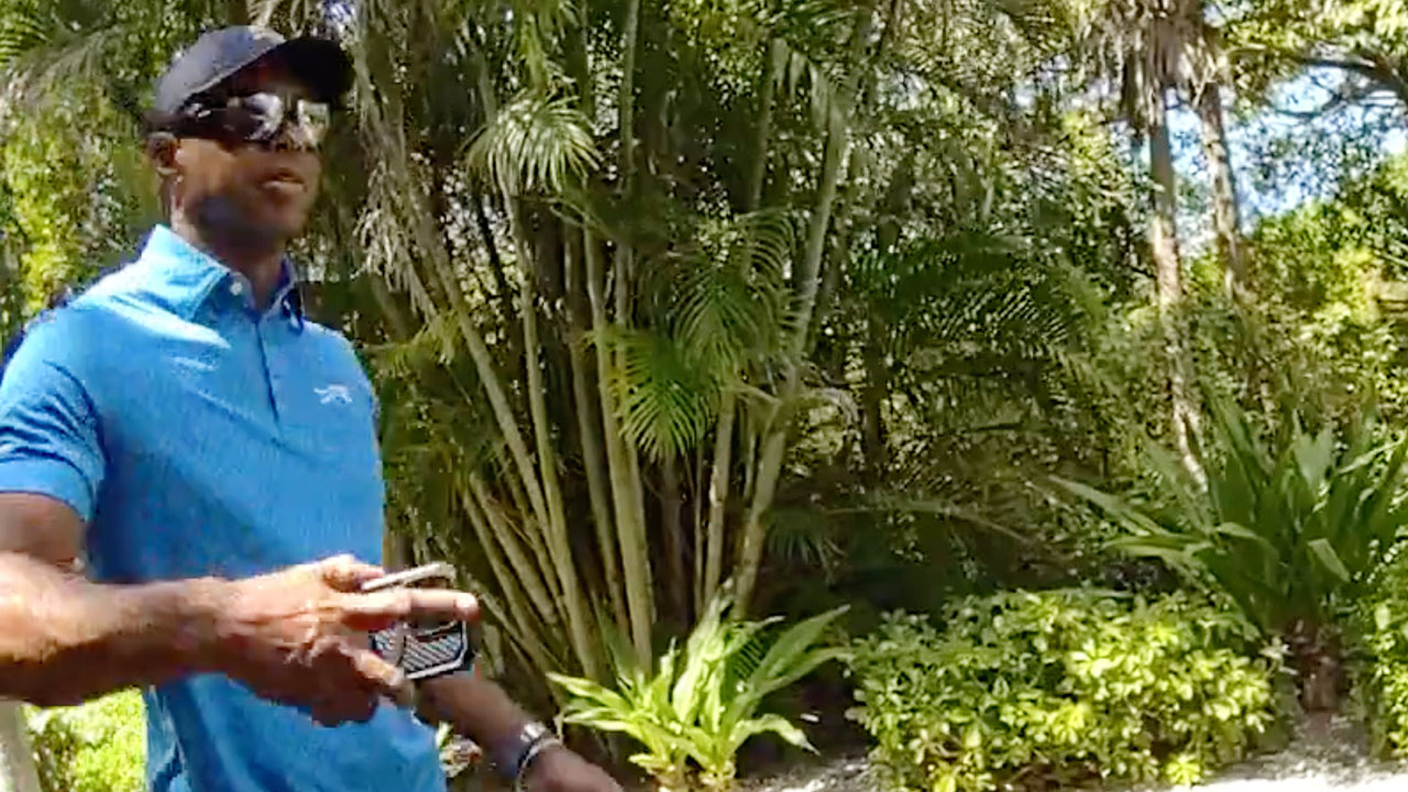 In this image from police body camera video released by the Martin County, Fla., Sheriff's Office, golfer Tiger Woods hangs up his cellphone and tells a sheriff deputy “I was just talking to the president" following a car crash in Jupiter Island, Fla., Friday, March 27, 2026.
