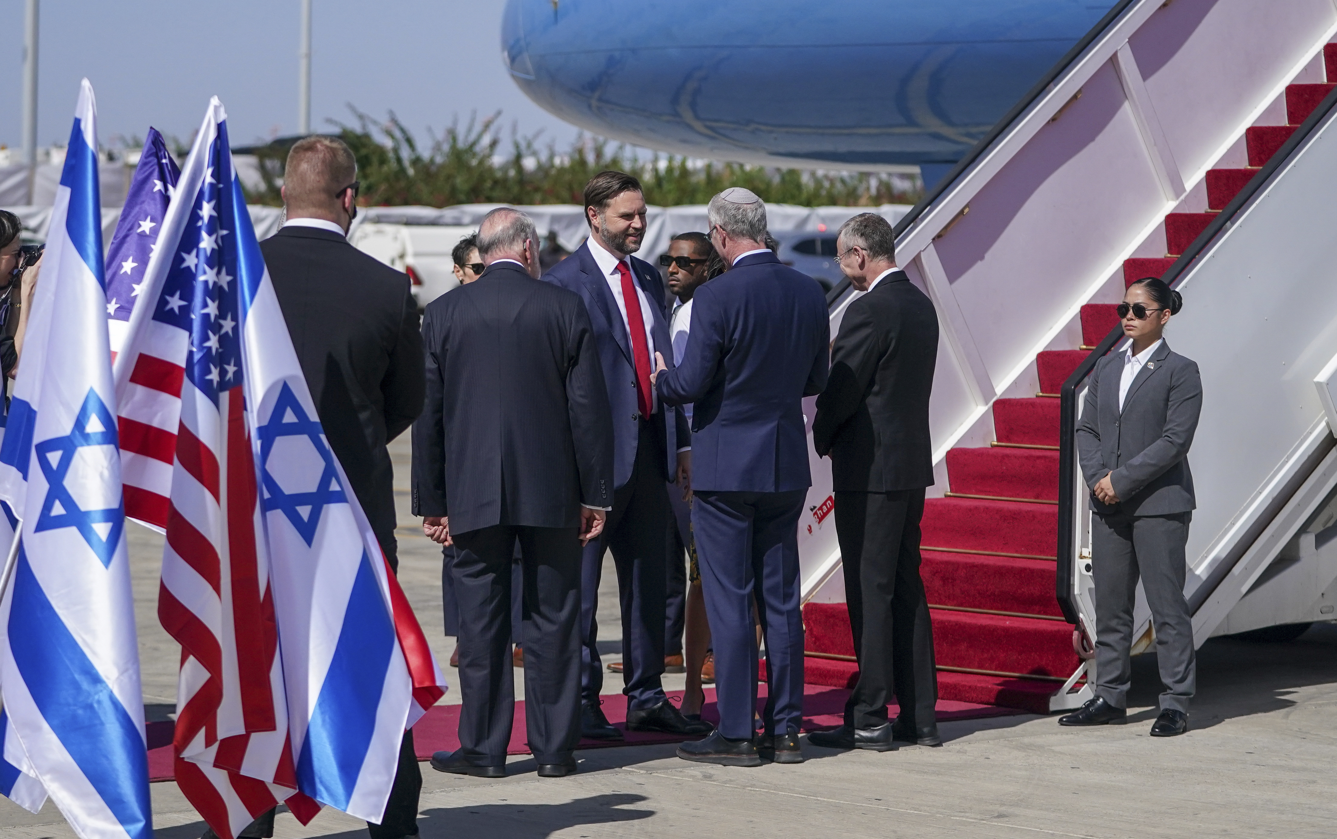Vice President J.D. Vance, center, is welcomed by Israeli ambassador to the U.S. Yechiel Leiter and U.S. ambassador to Israel Mike Huckabee, back to camera, upon his arrival at Ben Gurion airport in Tel Aviv, Israel, Tuesday, Oct. 21, 2025. 