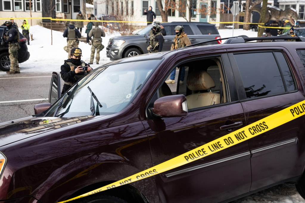 A bullet hole and blood stains are seen in a crashed vehicle on at the scene of a shooting in Minneapolis on Wednesday, Jan. 7, 2026.  