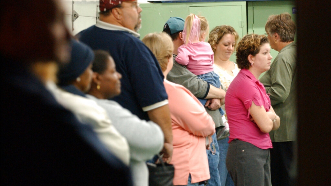 Voters wait in line to cast their ballots