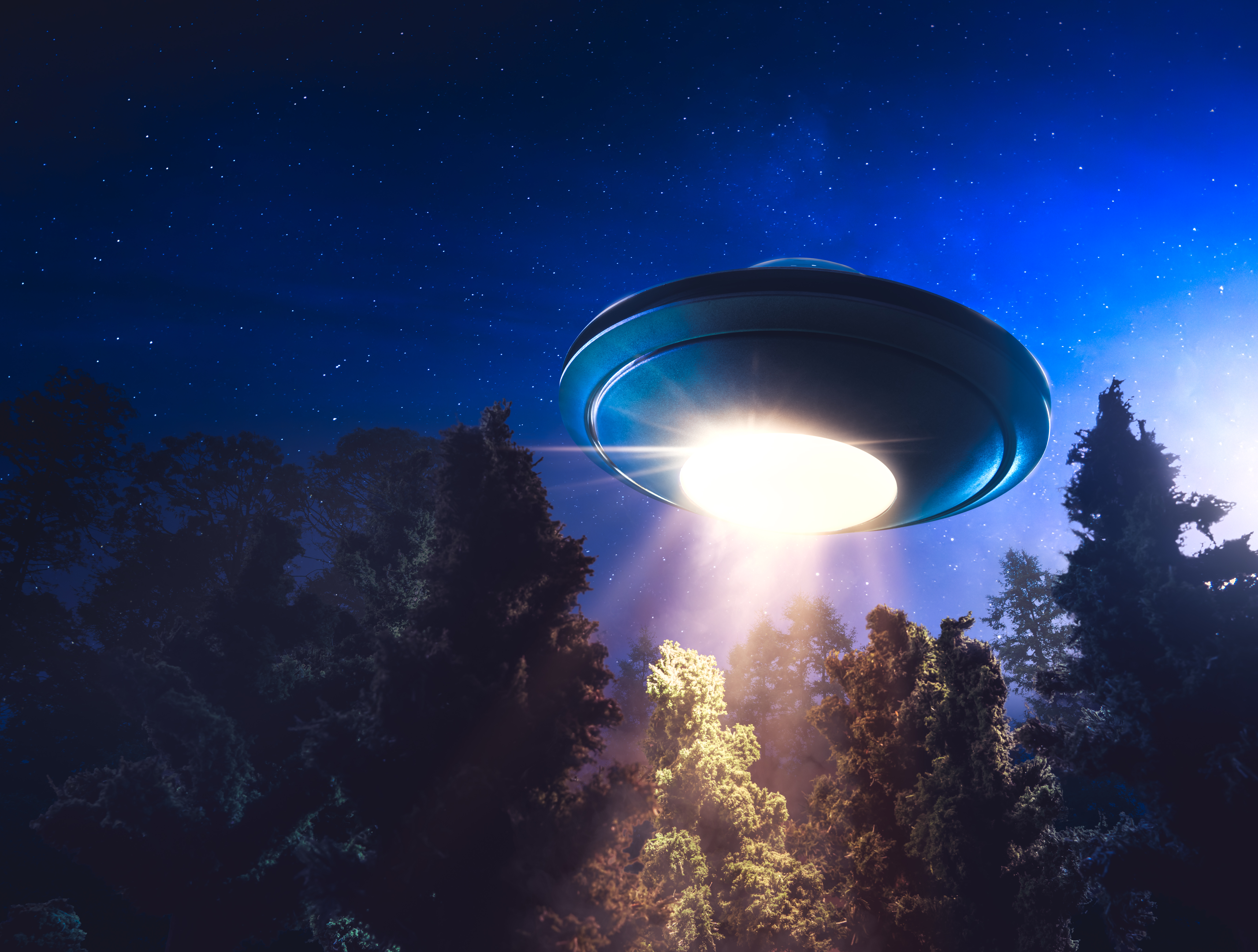 High contrast image of UFO flying over a forest with light beam at night