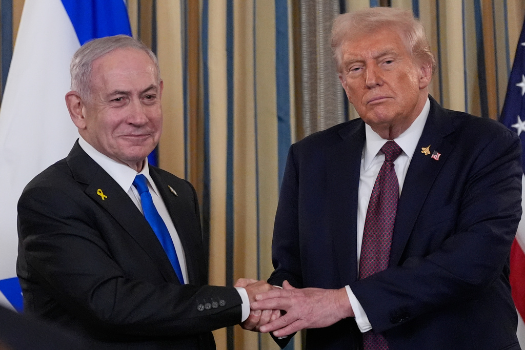 Israel's Prime Minister Benjamin Netanyahu shakes hands with President Donald Trump after a news conference in the State Dining Room of the White House.