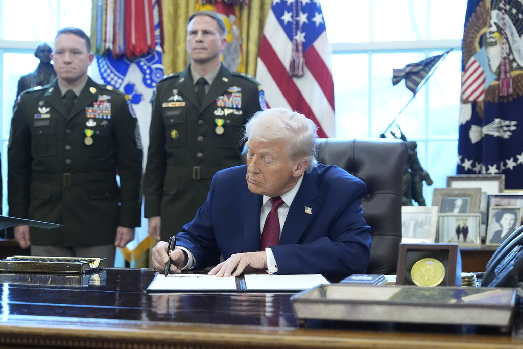 President Donald Trump signs a proclamation during a Mexican Border Defense Medal presentation in the Oval Office of the White House, Monday, Dec. 15, 2025, in Washington. 