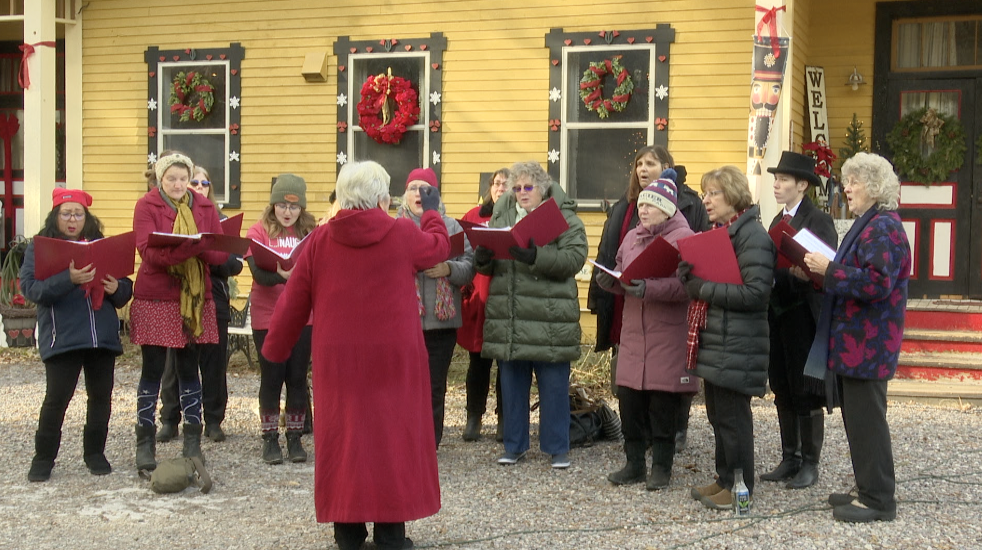 Carolers outside the 9 Mile Schoolhouse, Huson
