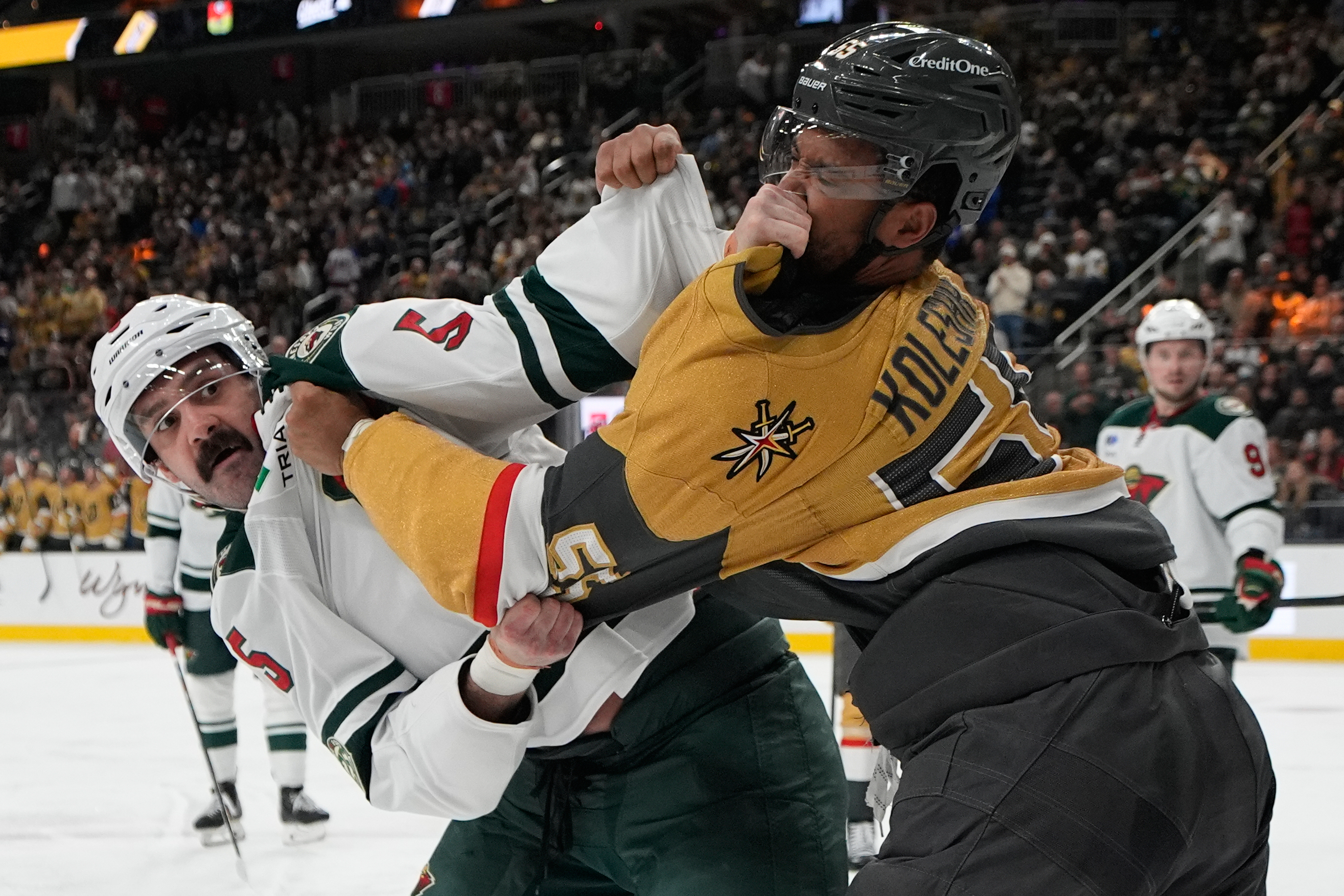 Minnesota Wild defenseman Jake Middleton, left, and Vegas Golden Knights right wing Keegan Kolesar (55) fight during the second period of an NHL hockey game Friday, March 6, 2026, in Las Vegas. 