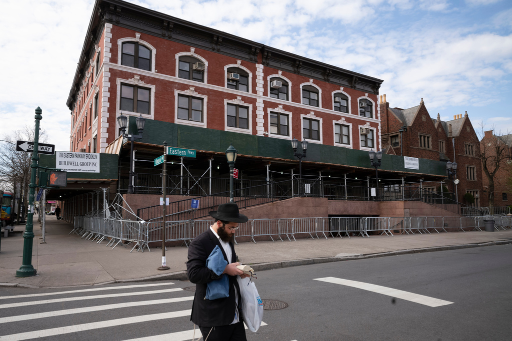 A man passes the Chabad-Lubavitch World Headquarters in the Crown Heights neighborhood of Brooklyn, April 7, 2020 in New York. 