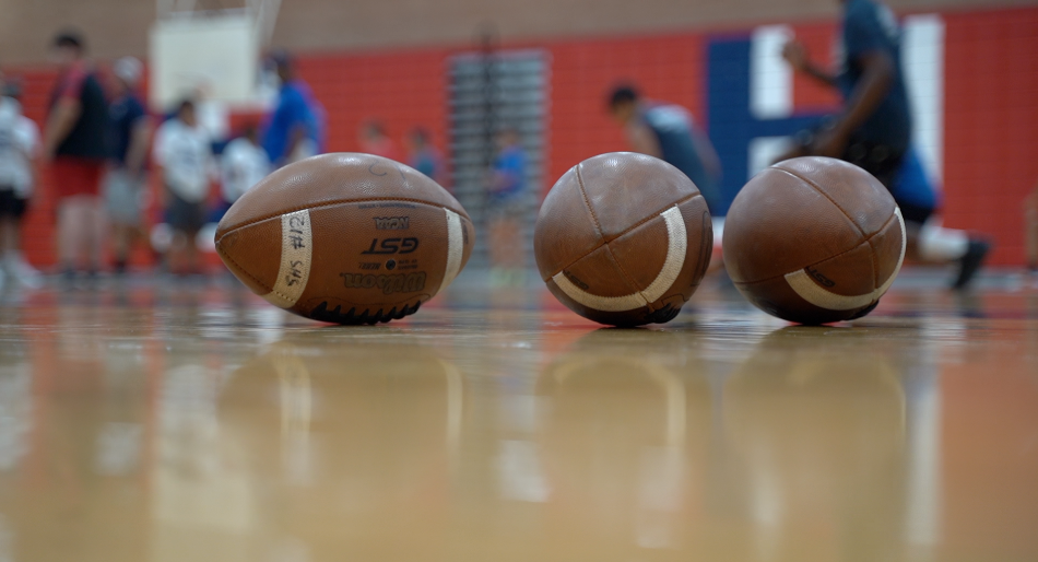 Footballs on a basketball court in Tucson, Arizona
