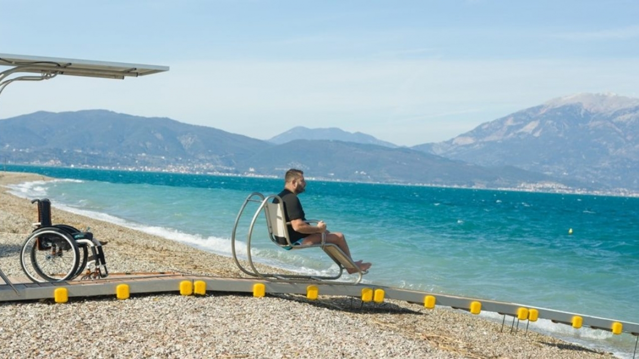 Man uses ramp to access water on beach
