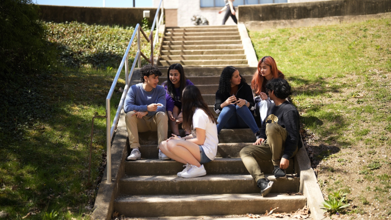 Upper Darby High School students sit on steps outside of school.