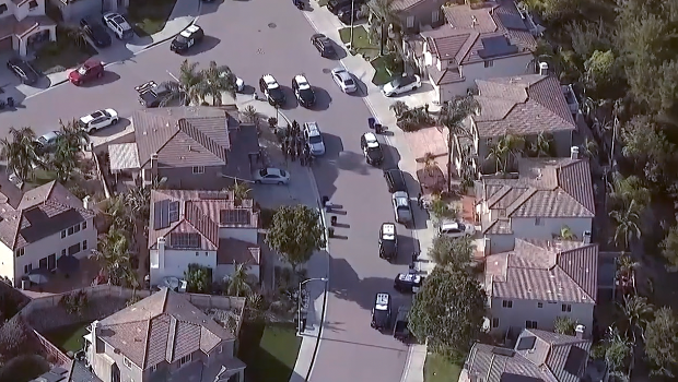 Authorities surrounded a Chula Vista home on Tuesday believed to be linked to one of the shooters in Monday's mass shooting at the Islamic Center of San Diego.