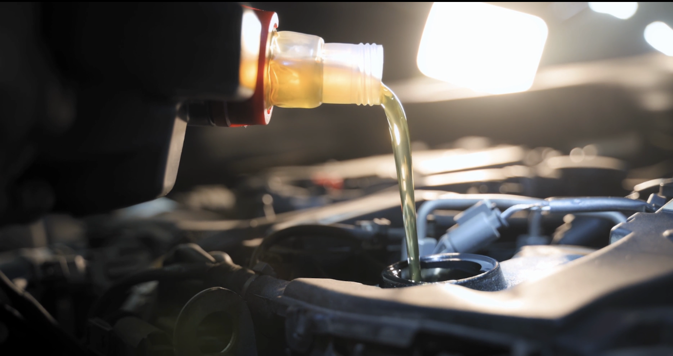 FILE: Oil is being poured into a vehicle.