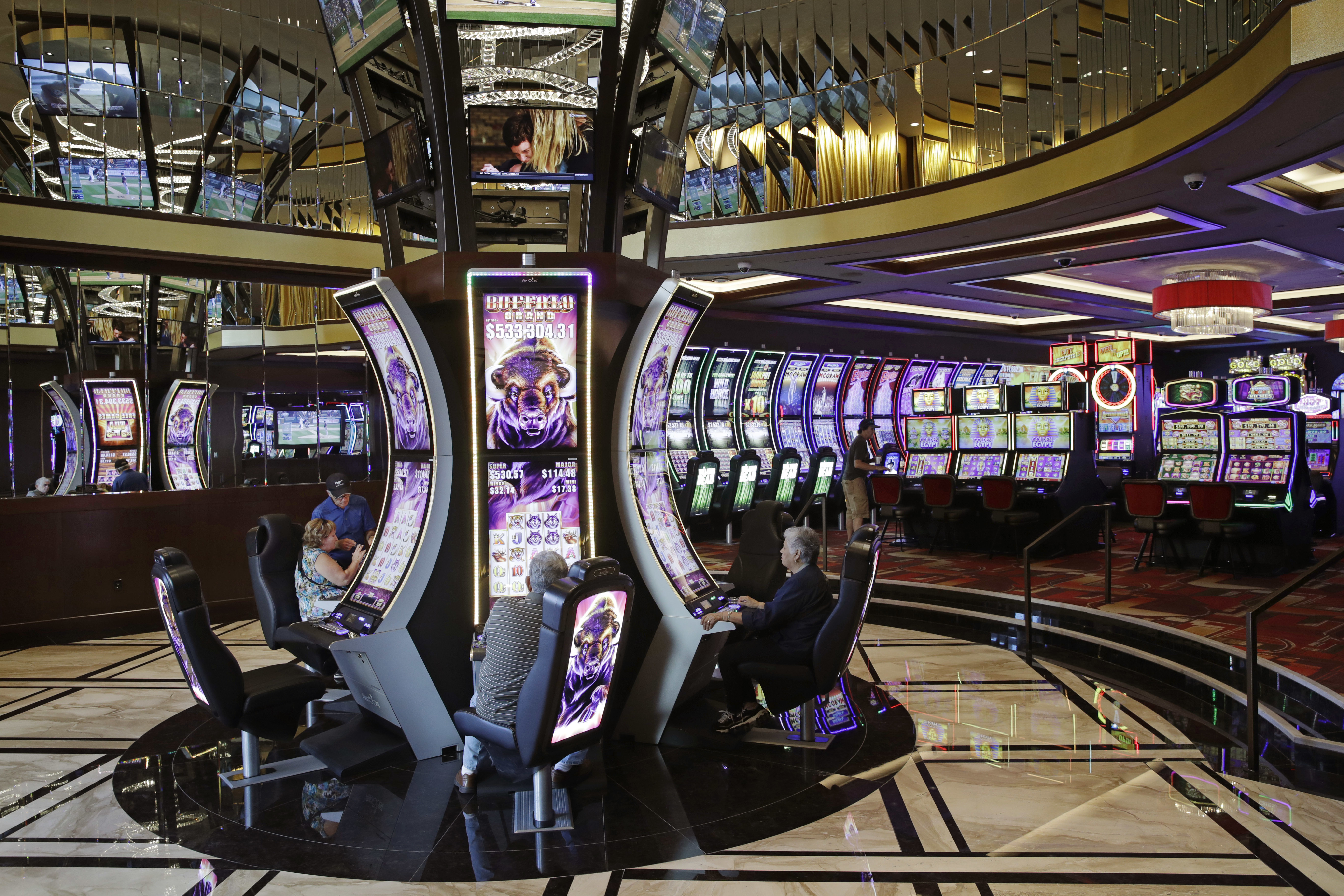 People play slot machines in a newly opened expansion at the Golden Gate hotel-casino, Friday, Sept. 1, 2017, in Las Vegas. 