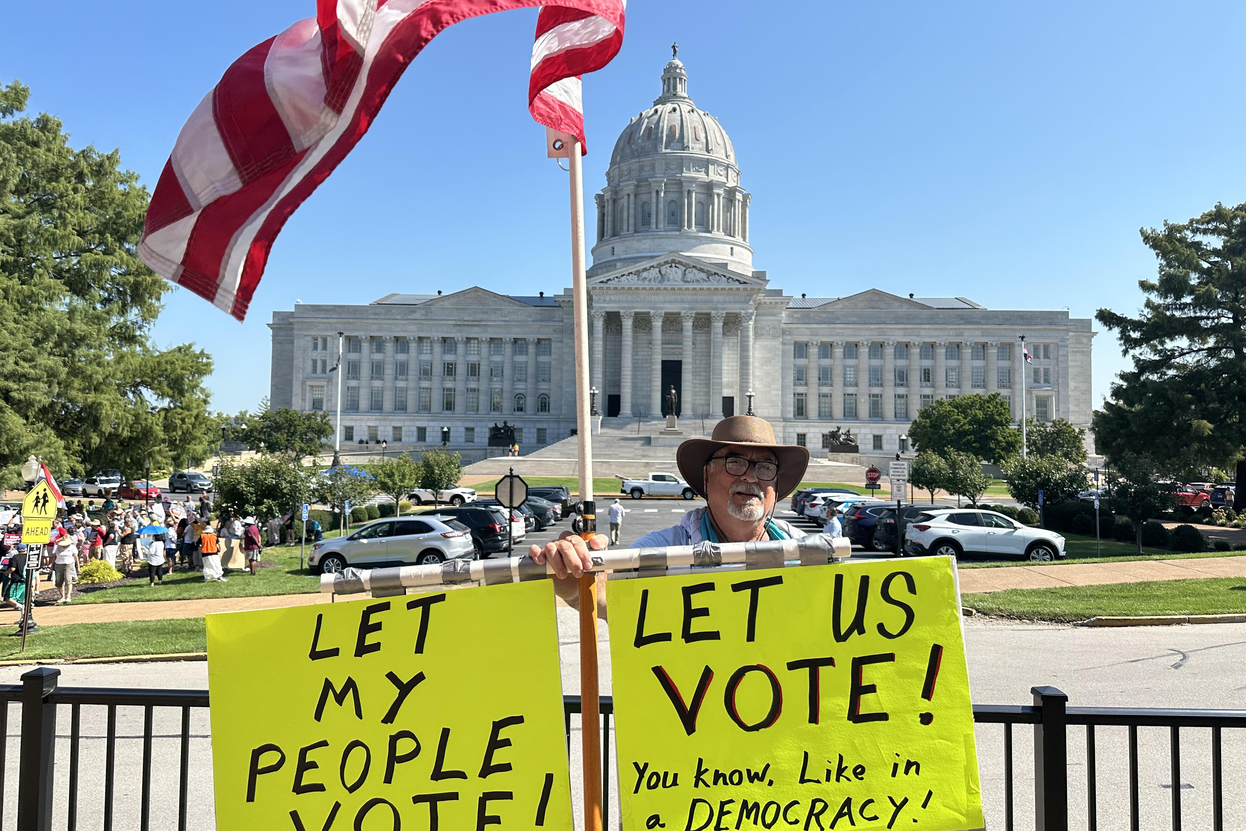 In this photo taken with a smartphone, Steve Dakopolos demonstrates in front of the state Capitol in Jefferson City, Mo., Wednesday, Sept. 2, 2026, in support of a referendum petition seeking a statewide vote on a congressional redistricting plan.