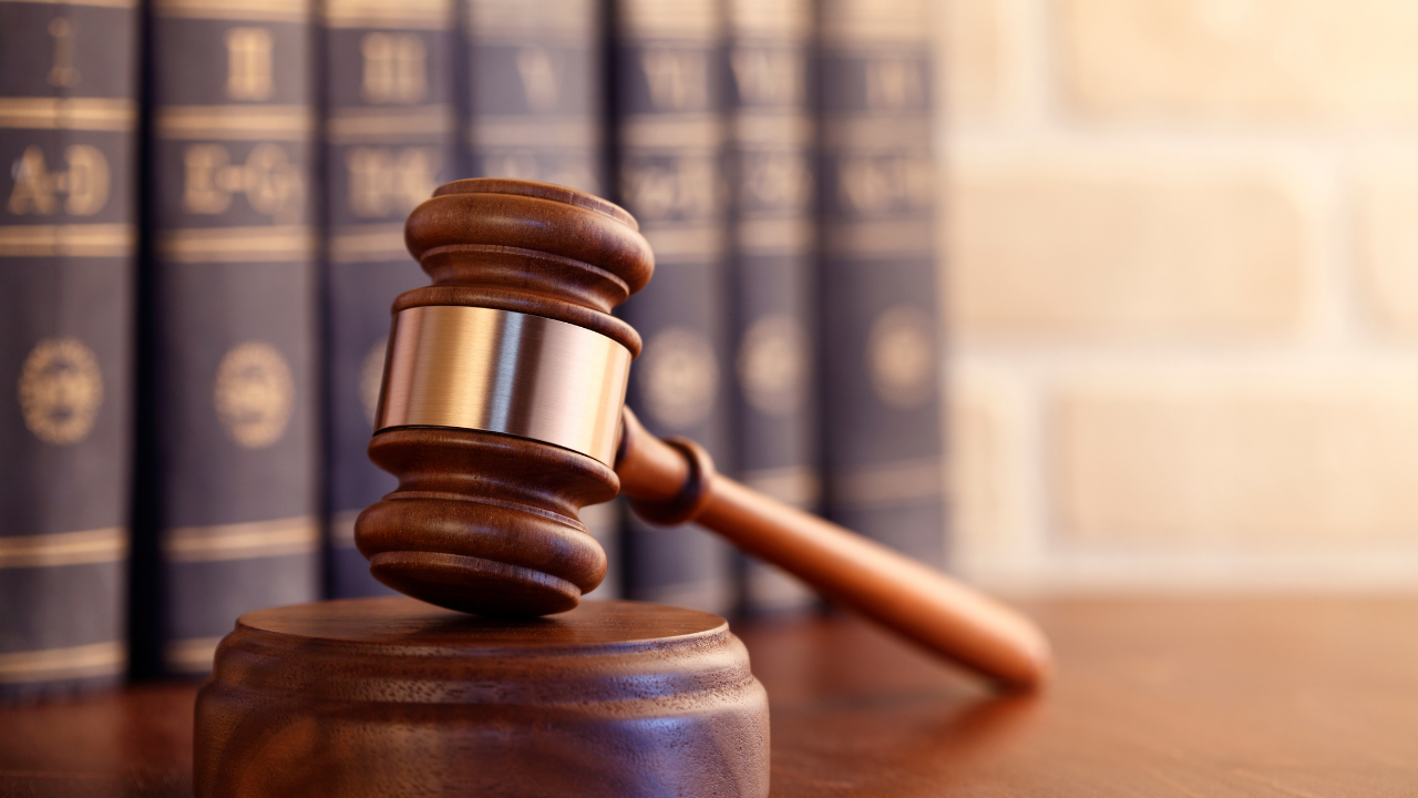 File image of a gavel in front of law books. 