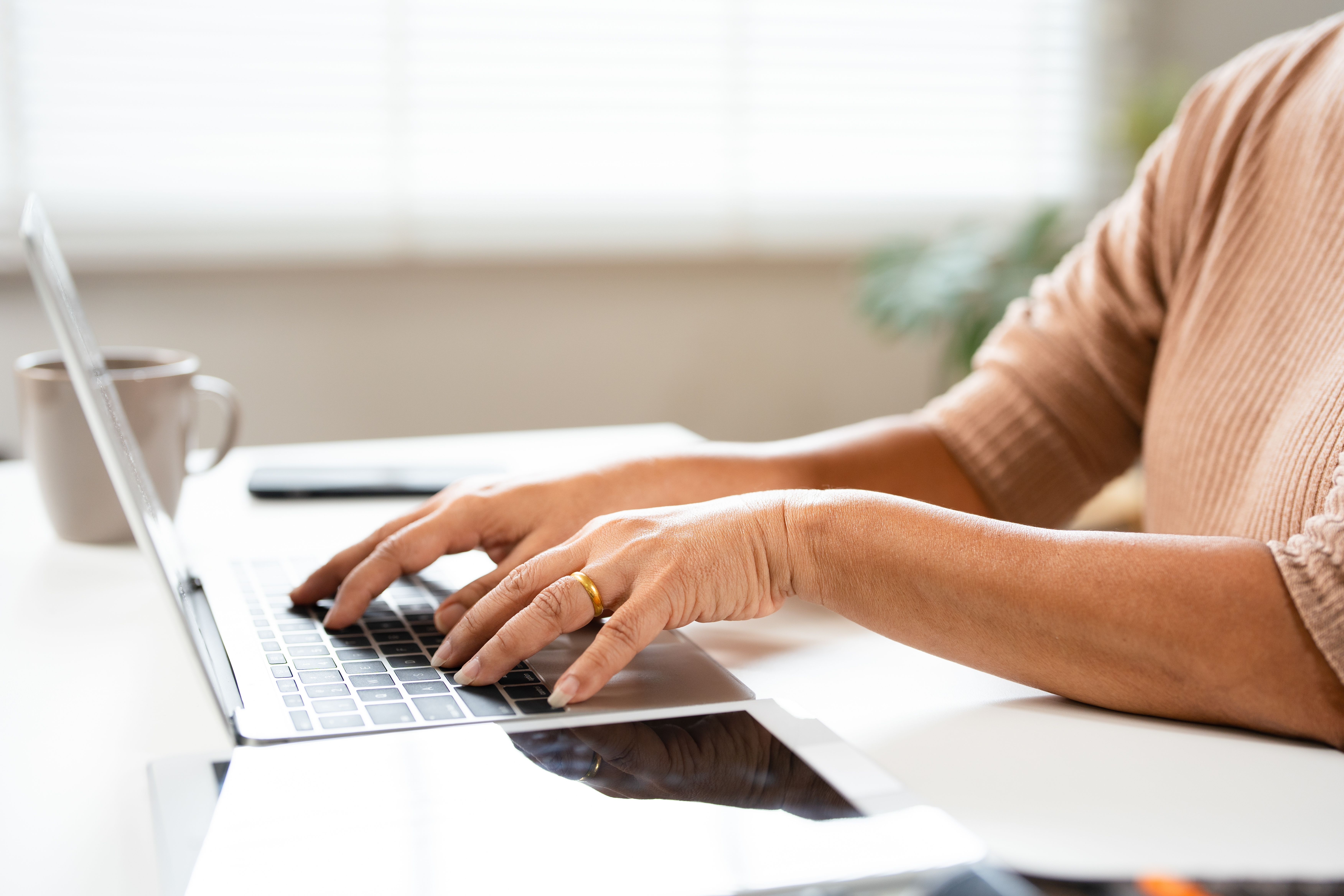 A woman doing her taxes on her laptop. 