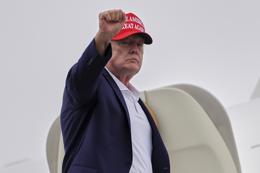 President Donald Trump gestures as he boards Air Force One at Morristown Airport, Sunday, Aug. 16, 2026, in Morristown, N.J.